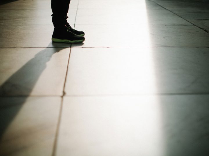 teen standing in shadows