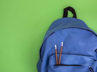 blue school knapsack with pencils